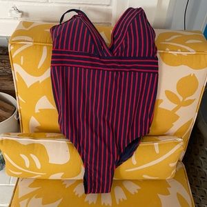 Brand new one piece blue suit with red stripes